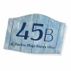 House number sign with street name - Graphic design. Simple style with large numbers and text on a wood-like background.