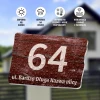 House number sign - Rectangular plaque with number 64, brown background, graphic design.