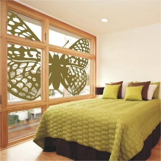 A butterfly in a soft green shade, enhancing a modern bedroom with large windows.