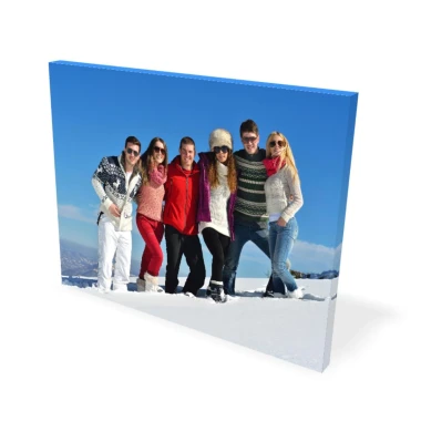 Canvas print 75x100 cm - Outdoor scene with a group of people standing in the snow against a blue sky backdrop.