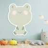 Magnetic dry-erase frog board for kids, styled in a bright children\'s room with light walls and flooring.