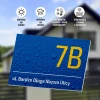 Address plaque with street and house number - Graphic design. Blue background with water droplets, white text with number and name.