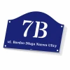 House number sign with street name - Graphic design. Navy background with white numbers and letters, semicircular shape.