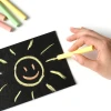 Chalkboard film - black - with a graphic design of a smiling sun and rays on the surface.