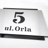 Engraved address plaque in brushed silver and black dibond, 42 x 35 cm, featuring a graphic design.