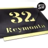 Engraved address plaque in dibond 42 x 35 cm black-gold - Graphic design. Black front with cut-out numbers and text.