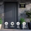 Engraved address plaque in black and gold dibond, 42 x 35 cm - Modern entrance decor with gray-toned walls.