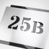 Engraved address plaque in brushed silver-black dibond, 42 x 35 cm, with cut-out silver numbers 25B.