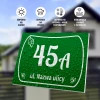 House number sign, street - Graphic design. Green sign with white numbers and text, water droplets on the surface.