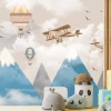 Children\'s room wallpaper with planes, mountains, and balloons. Brightly colored walls for a playful atmosphere.