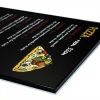Magnetic chalkboard in an aluminum frame with a graphic print of a pizza slice with various toppings.