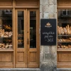 Magnetic chalkboard with custom print in any size — Bakery storefront arrangement. Stone walls, wooden doors and display windows.