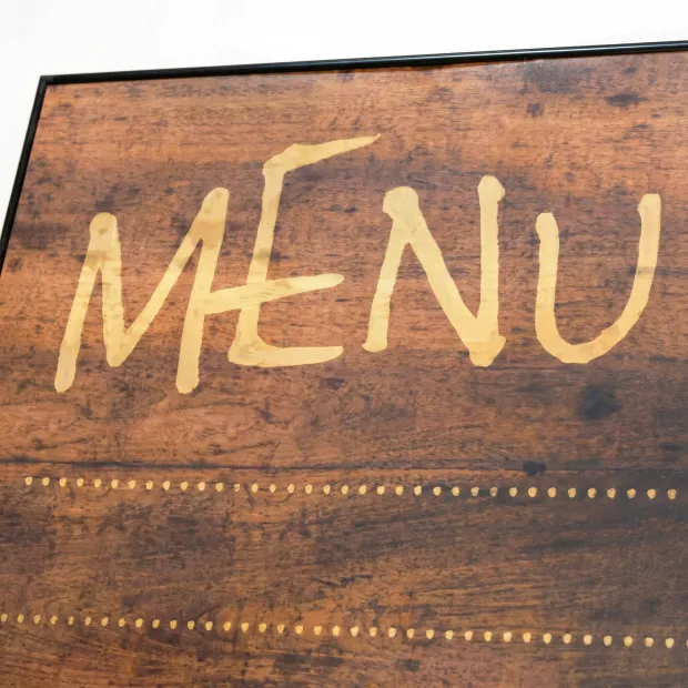 Magnetic chalkboard in an aluminum frame with a graphic design featuring the word MENU in color.
