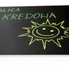 Custom chalkboard - chalk markers - Graphic design. A green smiling emoji on a black background.