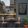 Custom chalkboard - Café decor. Light-colored walls, wooden furniture, table, and chairs.