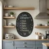 Round chalkboard for kitchen decor. Blue-toned walls with modern furniture and appliances.