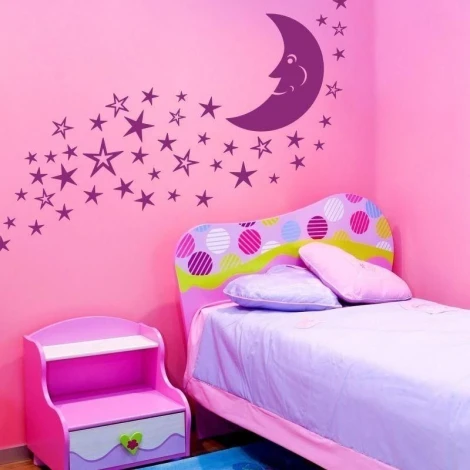 Moon and star stickers in a pastel nursery, perfect for creating a magical atmosphere.