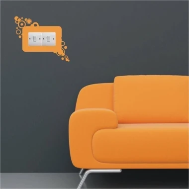 Colorful outlet sticker 1107 in a modern living room with an orange sofa, adding energy and style.