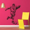 Dynamic soccer player wall art template on a vibrant pink wall, perfect for a child\'s sports room.