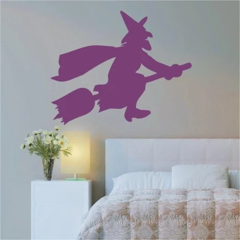 Magenta witch on a broom in a modern bedroom, adding character and magic to the decor.