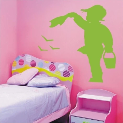 A boy painting on a pink wall in a cheerful children\'s room, adding charm and color to the space.