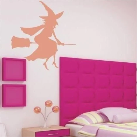 Magical witch on a pink wall in a child\'s room, adding charm and fantasy to the decor.