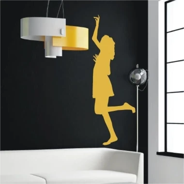 Woman in a dynamic pose against a black wall in a modern living room, adding energy and style to the space.