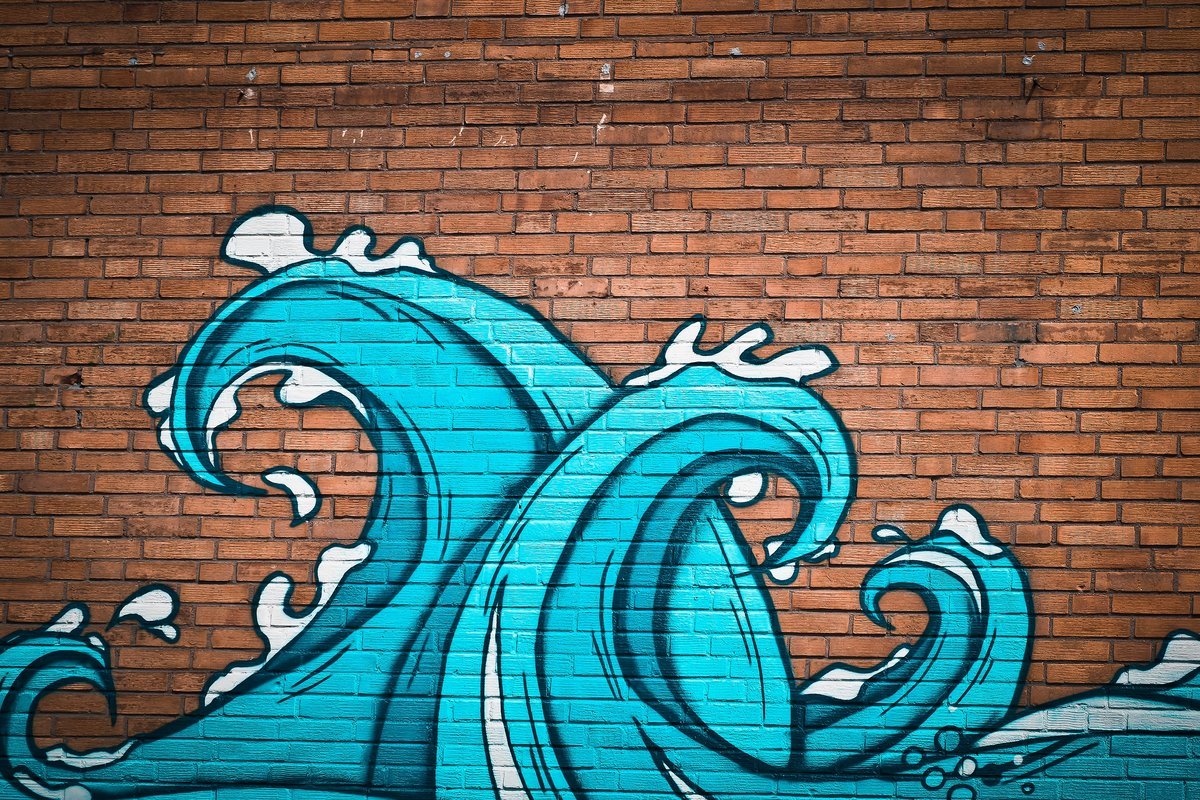 A photo wallpaper illustrating blue waves on a brick wall