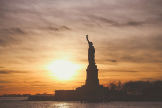 Wallpaper the statue of liberty in the glow of setting sun fp 5533